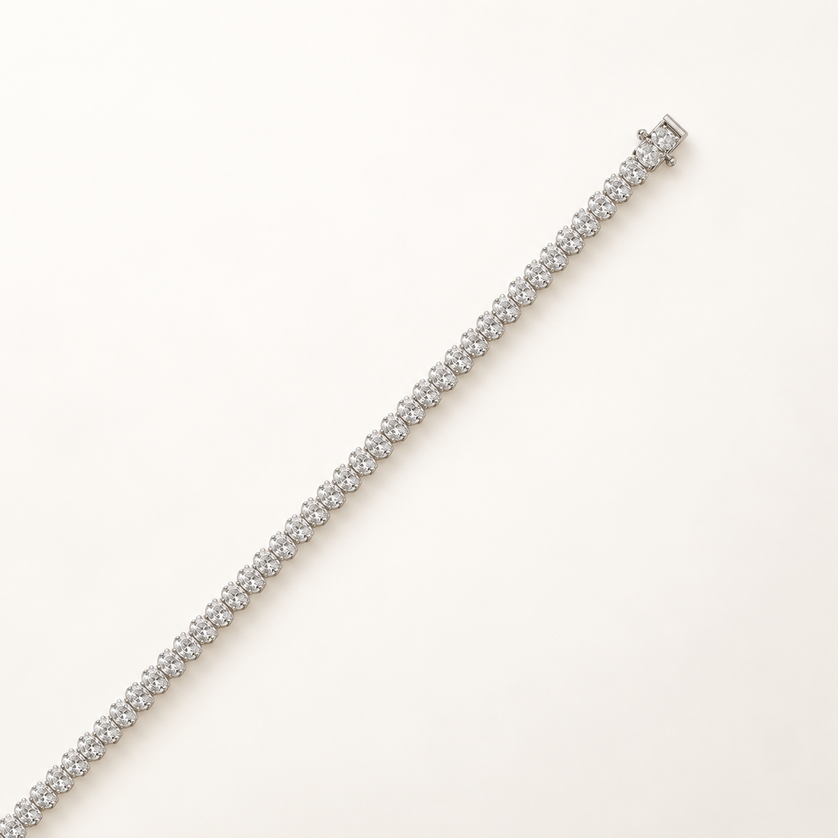 Oval-cut diamond tennis bracelet in white gold, closed clasp detail