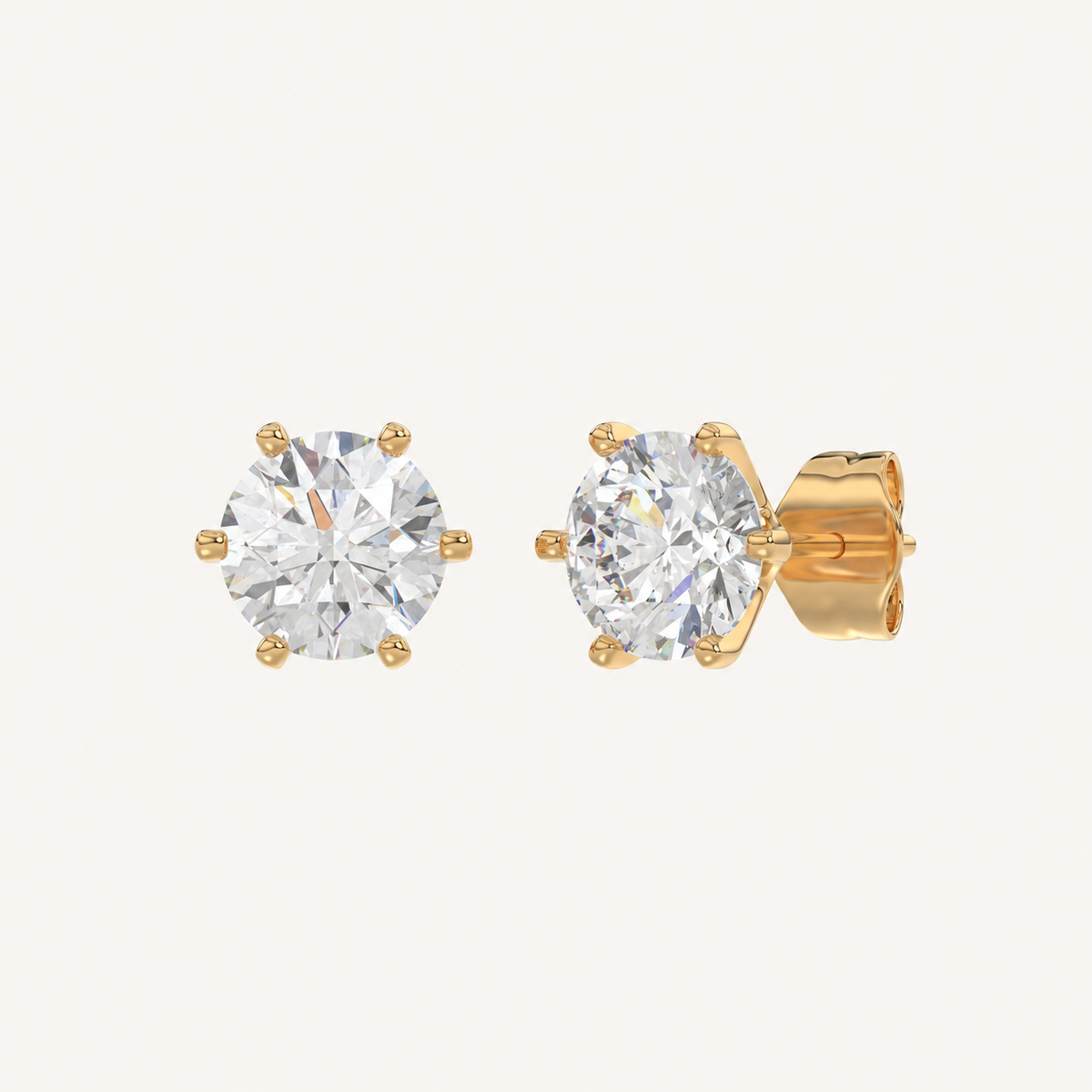 Six-prong round basket lab-grown diamond stud earrings in yellow gold, angled view