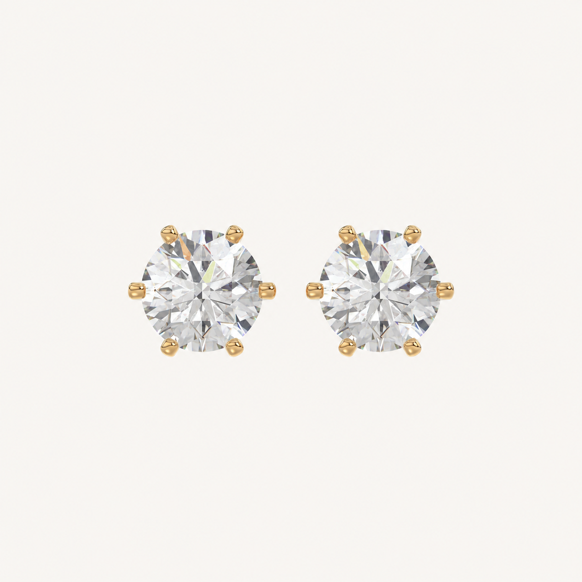 Six-prong round basket lab-grown diamond stud earrings in yellow gold, front pair view